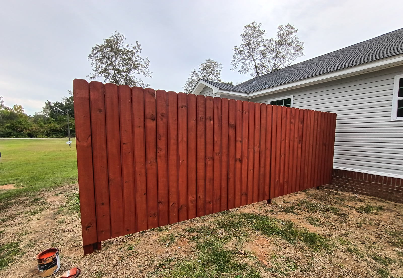 Custom stained wood privacy fence built by The Chain Link Pros